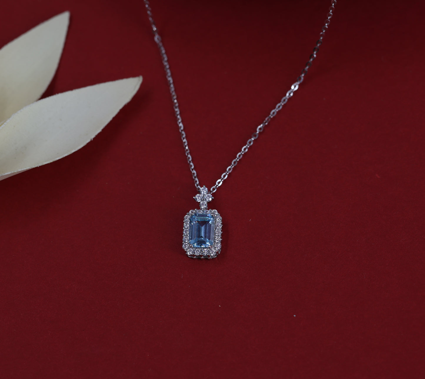 Elegant Blue Topaz Halo Necklace